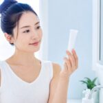 処方されたニキビの塗り薬を確かめる日本人女性